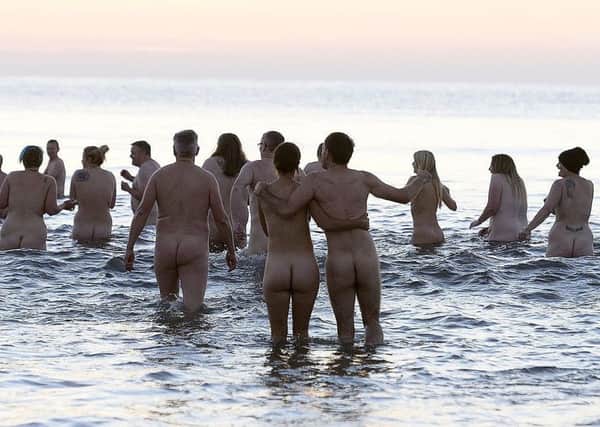 People attempt to set a new world record for the biggest ever skinny dip at a past event at Druridge Bay in Northumberland.