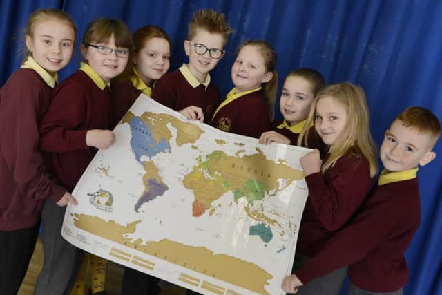 Pupils at Widdrington Grange with the map they used to show how far their posts had reached.
 Picture by Jane Coltman