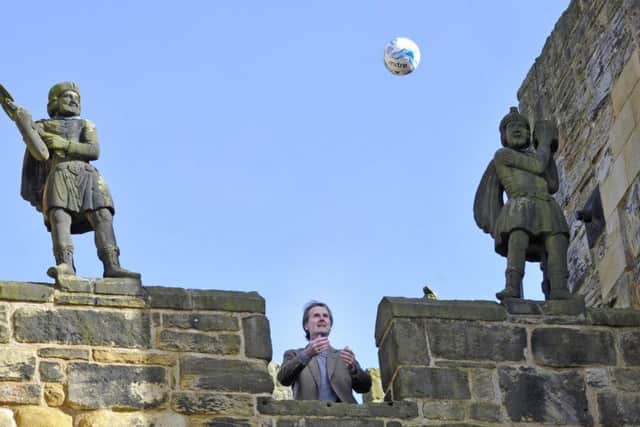 The Duke of Northumberland throws the match ball from the Barbican at Alnwick Castle.