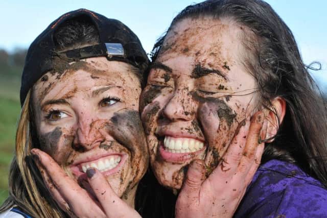 Muddy faces - two of the Shrovetide match players from St Coud State University.