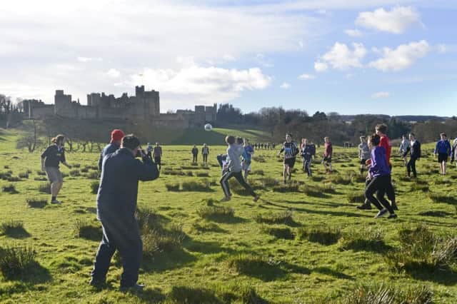 The annual Shrove Tuesday football match in the pastures by Alnwick Castle.
 Picture by Jane Coltman