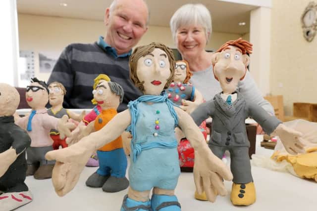 The Duke and Duchess of Northumberland in clay form, with residents Michael and Rosie Bedford in the background.
