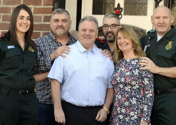 Colin Flannery and his wife Gail, neighbour Derek Scott and North East Ambulance Service staff Claire Gilroy, Graeme Scott and Graham Curry.
 Picture by Jane Coltman