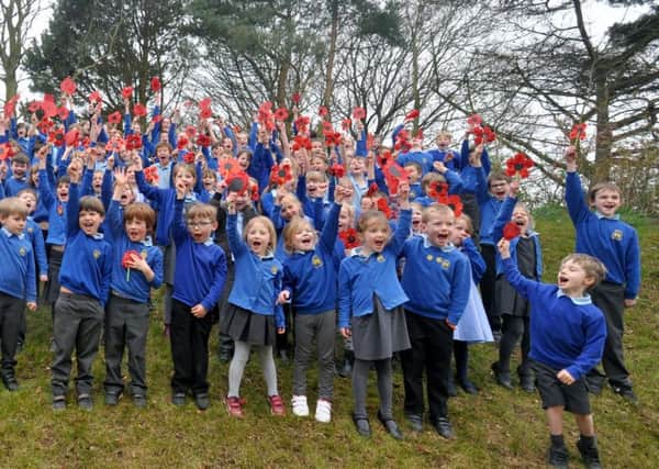 Hipsburn First School pupils with their poppies. Picture by Terry Collinson