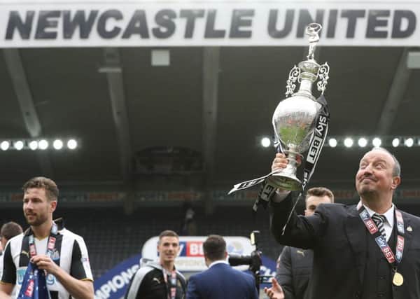 Newcastle United manager Rafa Benitez celebrates with the Sky Bet Championship trophy. Picture by Owen Humphreys/PA Wire