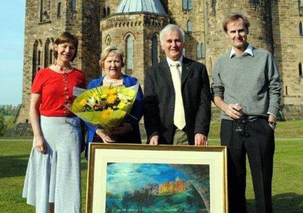 Graham Luke and his wife Eileen, with his retirment gift from the Duke and Duchess of Northumberland (also pictured).