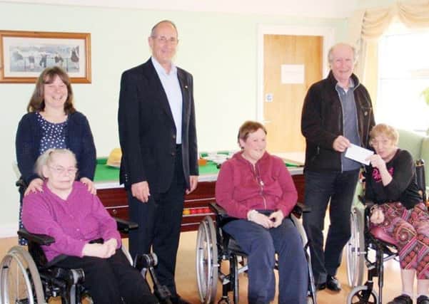Amble and Warkworth Rotarians Mike Frisch and Paul Creighton (presenting the cheque to resident Trudi), Nichola Bell (The Manager) with two more residents of Elpha Lodge. Picture by Rtn John Young