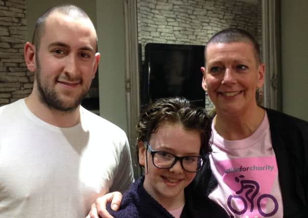 Helga Charters, her daughter Victoria and Jeff Castle of Boots Opticians in Morpeth after the head shaves and hair cut.