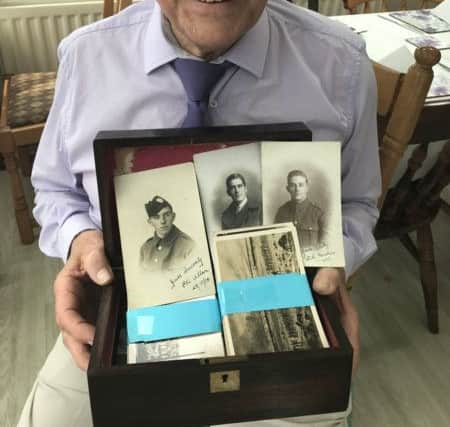 Ernie Broom with the box of postcards left by his wife Deirdre's parents.