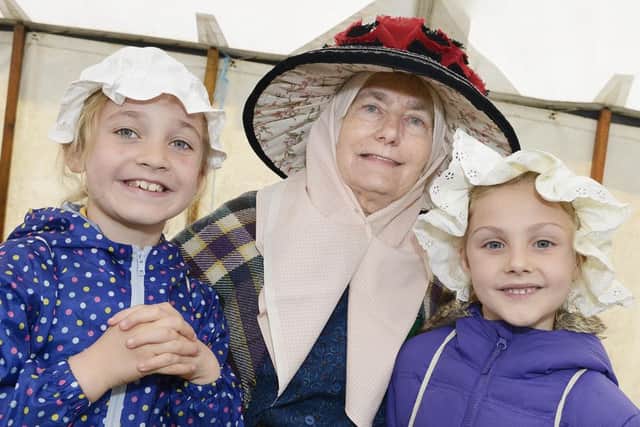 Rothbury pupils Abby Barnes and Emma Crane with Bondager Dorothy Sharpe at the Children's Countryside Day at Wooler.
 Picture by Jane Coltman