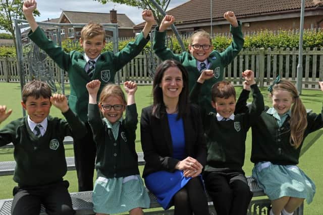 Bede Academy students Scott Green, Eve Turner, Luke Gannie, Jasmine Krzysiak, David Skierski and Ruby Jones celebrate with head of primary years Bethan Harding, who has been made an MBE.