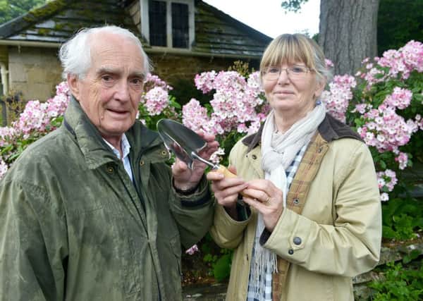 Maureen Kesteven from the National Garden Scheme presents Tim Norton with an engraved trowel to mark the ten years that the gardens at Whalton Manor have opened for the scheme.  Picture by Jane Coltman.