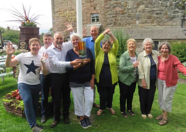 Beadnell villagers, including Katie Archer (fourth from the left) celebrate their Northumbie triumph at the Craster Arms, which played a big part in the celebrations. The award was sponsored by The Northumbrian magazine.