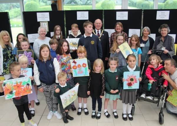 The winners of the painting competition, with officials.