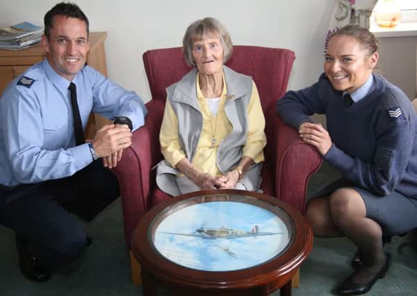 Sergeant Chris Fleming, Marjorie Moir and Sergeant Kerry Chadwick with the Spitfire coffee table.