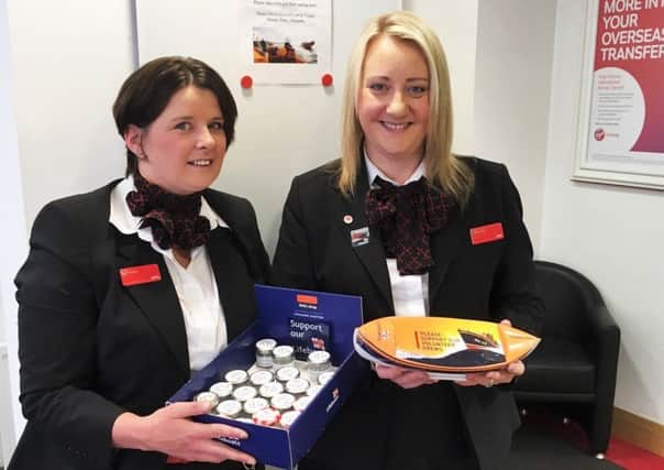 Virgin Money's Julie Little and Lisa Weir with some of the jars filled with 5ps.