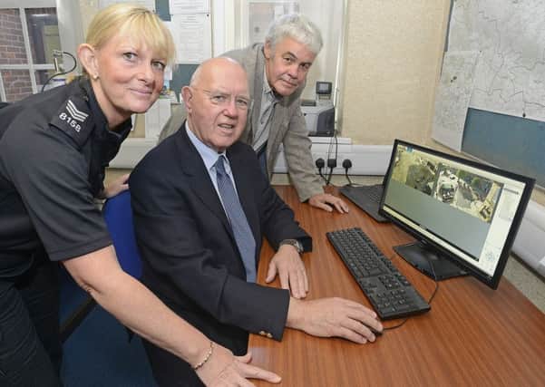Sergeant Sharon Wilmore-Greaves, Mayor Alan Symmonds and Tim Kirton, Alnwick Town Councils project officer, with the CCTV display in Alnwick Police Station.
 Picture by Jane Coltman