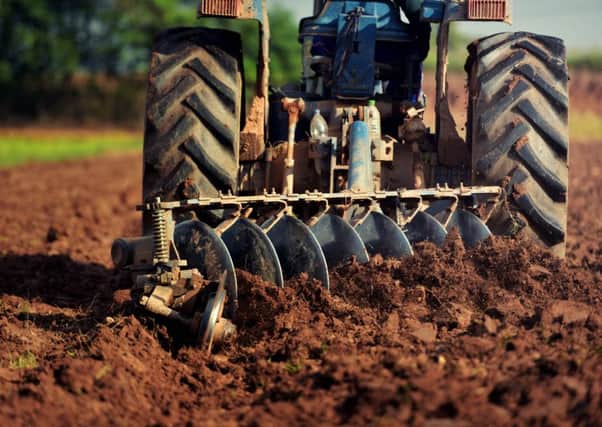 A tractor ploughing.