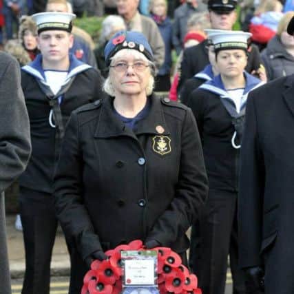 Catherine with a wreath, representing the WRNS at a previous Alnwick Remembrance parade.