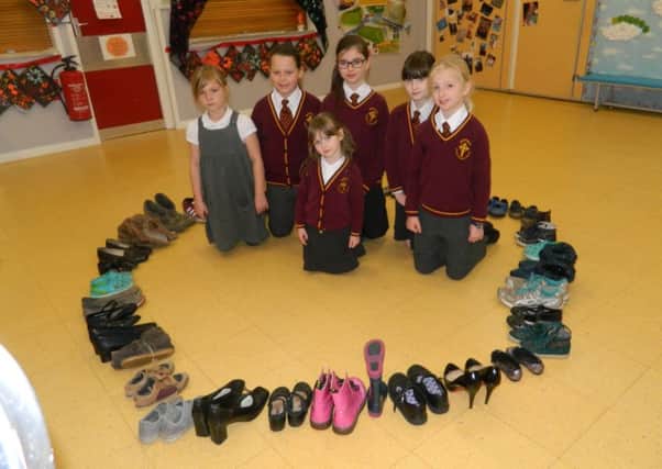 Pupils with some of the shoes being donated by Whittingham CofE Primary School.