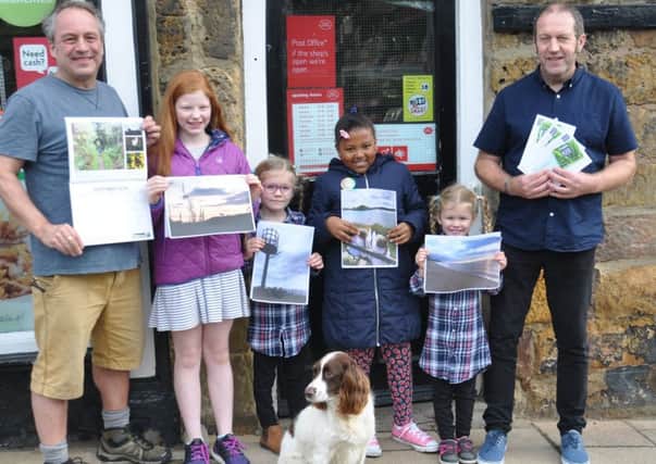Pictured with Nick Mattlock holding a copy of the calendar are some of
the young entrants with their photographs; Olivia Hands, Caitlin Youll, Mikaela Benn-Shallow, Georgie Youll and Robin Winder, who is the
Burgage Holders Moorgrieve, and Rosie the dog. Picture by Terry Collinson