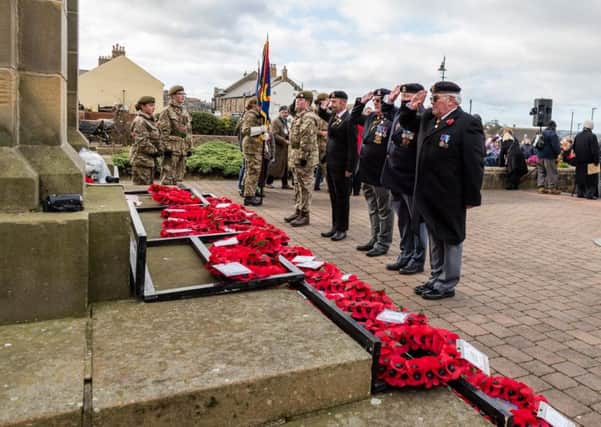 Paying respects at Amble. Picture by Andrew Mounsey