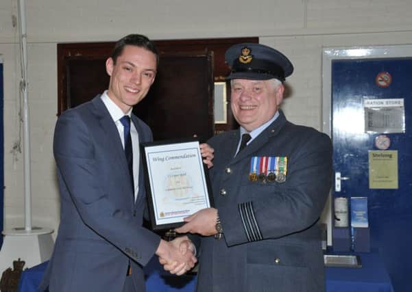 Conor Reed receives his first aid award from Wing Commander David Harris.