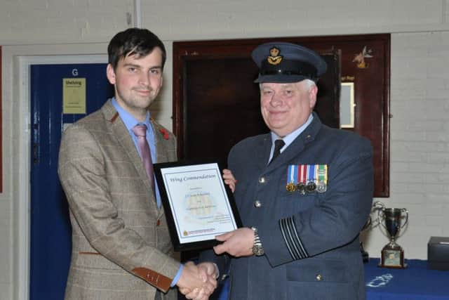 Sean Ashworth receives his first aid award from Wing Commander David Harris.