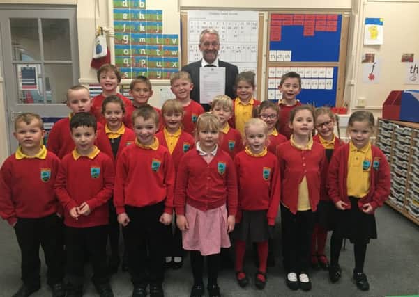 Headteacher Gary Parnaby with students at Shilbottle Primary School.