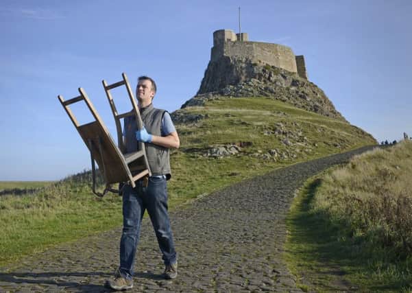 House steward Nick Lewis carries out one of the many items from Lindisfarne Castle last year.
Picture by Jane Coltman