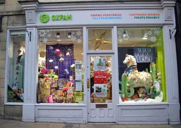 The llama Christmas card display, right window, at the Oxfam shop in Morpeth.