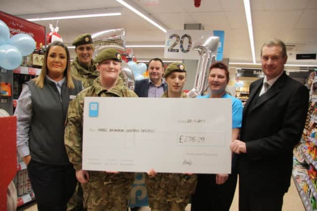A cheque to Amble Memorial Garden Project. From left: Rebeca Robinson, Sgt Katrina Cassidy, Lcpl Grainger, Shaun White, Cadet Wilkinson, Rebecca Haig and Roy Davison. Picture by Bartle Rippon/The Ambler
