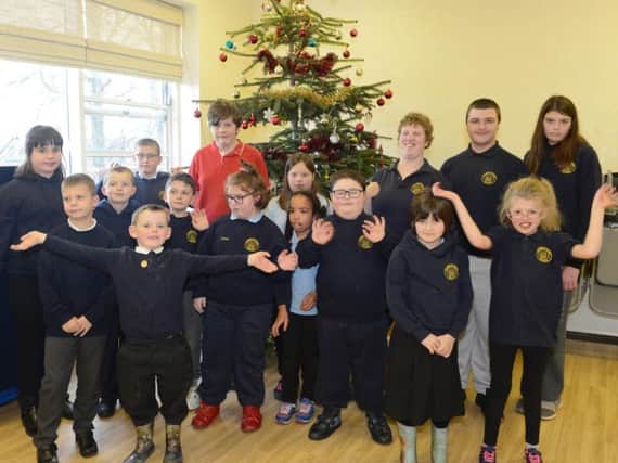 The youngsters from Barndale House School in Alnwick gather around their Christmas tree. Picture by Jane Coltman