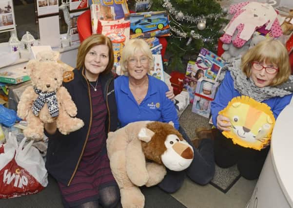 Wendy Dorothy, Jill Clark and Jenny Gascoigne with the collection of toys  collected in George F White's office through an appeal organised by the Rotary Club. Picture by Jane Coltman