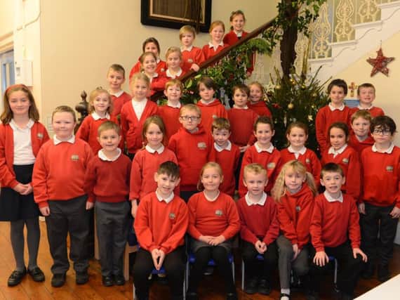 Pupils from Hugh Joicey CofE Aided First School gather around their Christmas tree to sing one of their carols. Picture by Jane Coltman