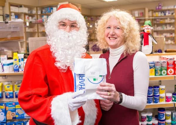 Santa and pharmacist Clair Fenwick at D&C Pharmacy, Cullercoats. Picture by Lee Hogan