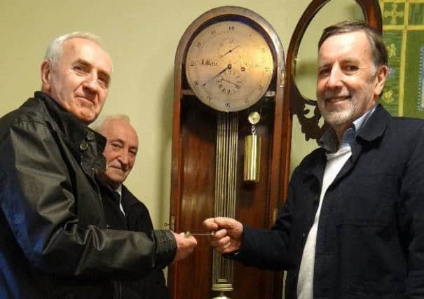 Peter Maule and brother John hand over the winding handle to Glendale Gateway Trust chairman Frank Mansfield.