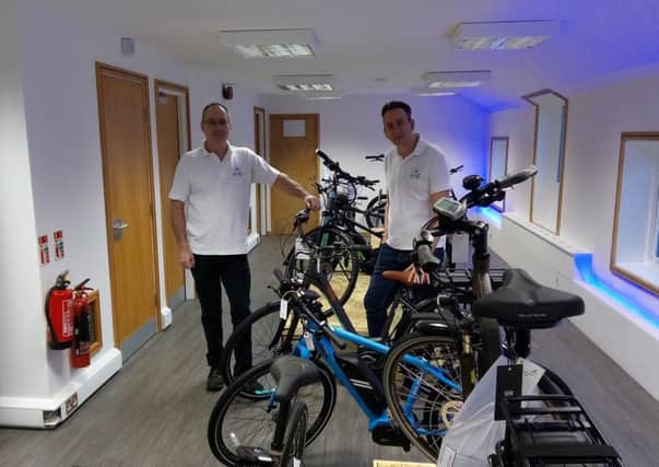 Ian Simpson, left, and Peter Bredael in the Morpeth Electric Bicycle Company showroom.