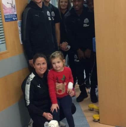 Evie Campbell is visited in hospital by players from Newcastle United's men's and women's teams.