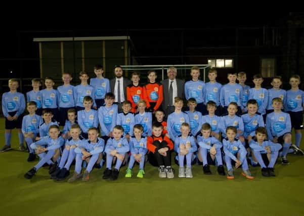 Neil Lisle, First Class Supply (back row, left) and Gavin Storey, headteacher of Cullercoats Primary School (back row, right) with youngsters wearing the new football kit provided by First Class Supply.