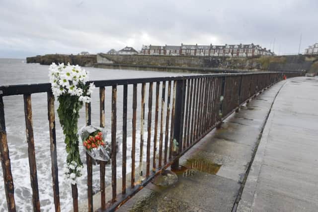Flowers left at Browns Bay near where Adam Langwells body was found. Picture by Jane Coltman