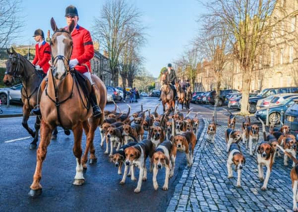 Huntsman Robert McCarthy and Whipper In Matthew Sewell bring the hounds along to the Percy Hunt meet at Alnwick Castle on New Year's Day 2018. Picture by Jane Coltman