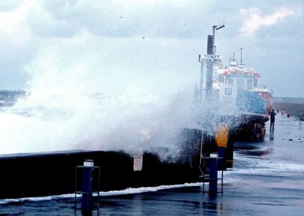 Big waves with the tidal surge at Seahouses harbour , Picture by Jane Coltman