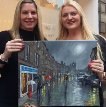 Karen Morrison and Samantha Tulloch, of Sage Wealth Management, with the bespoke painting by Pete Rumney.