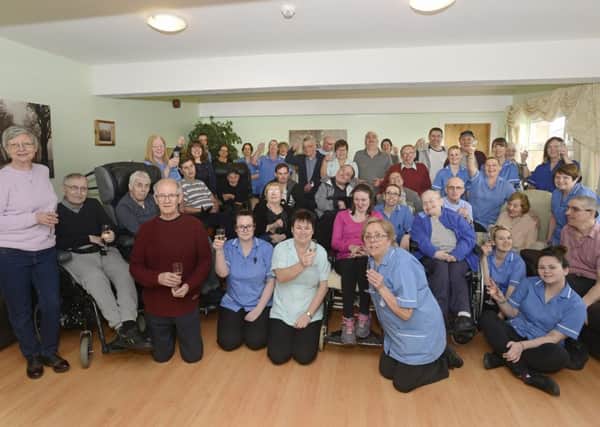Residents, staff and volunteers at Elpha Lodge celebrate their CQC success. Picture by Jane Coltman