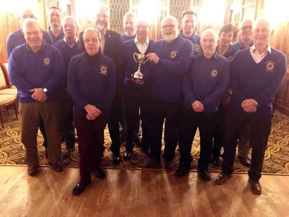 Alnwick Lions President Louis Warmington is being presented with the Top Club Cup by immediate past District Governor David Wheeler for the great service work that Alnwick Lions Club carried out in 2017, which included the Centennial Project with Swansfield Park Primary School, the Talking Newspaper, and the Bookshop.