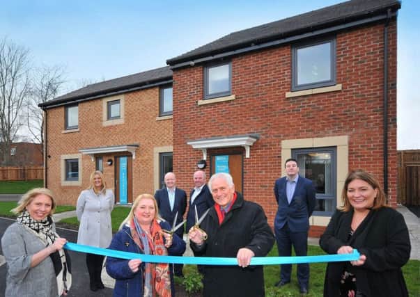 First resident Michelle Kalthoeber and Coun John Harrison, cabinet member for housing and transport with North Tyneside Council jointly cut the ribbon watched by (L-R) Riverside Home Ownerships new business and sales negotiator Jennifer Bailey, assistant sales manager Andrea Ellison, assistant director Andrew Williamson, project manager David Robinson, Sean Egan, managing director at Galliford Try and Riverside Home Ownerships sales negotiator Nonie Campbell.
