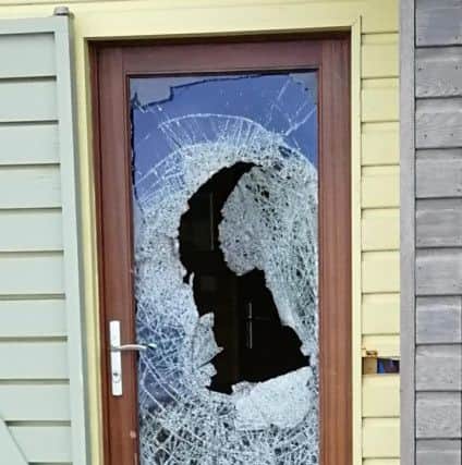 The damage to the door of one of the beach huts. Picture by Robert Ferry.