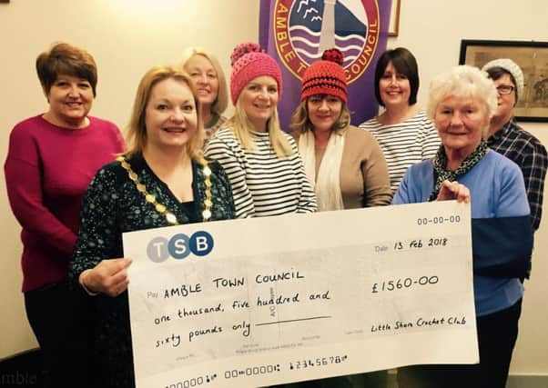 Members of the club present a cheque to Amble Mayor Jane Dargue.