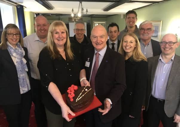 Members of the Tuesday Business Forum with their fund-raising cake.